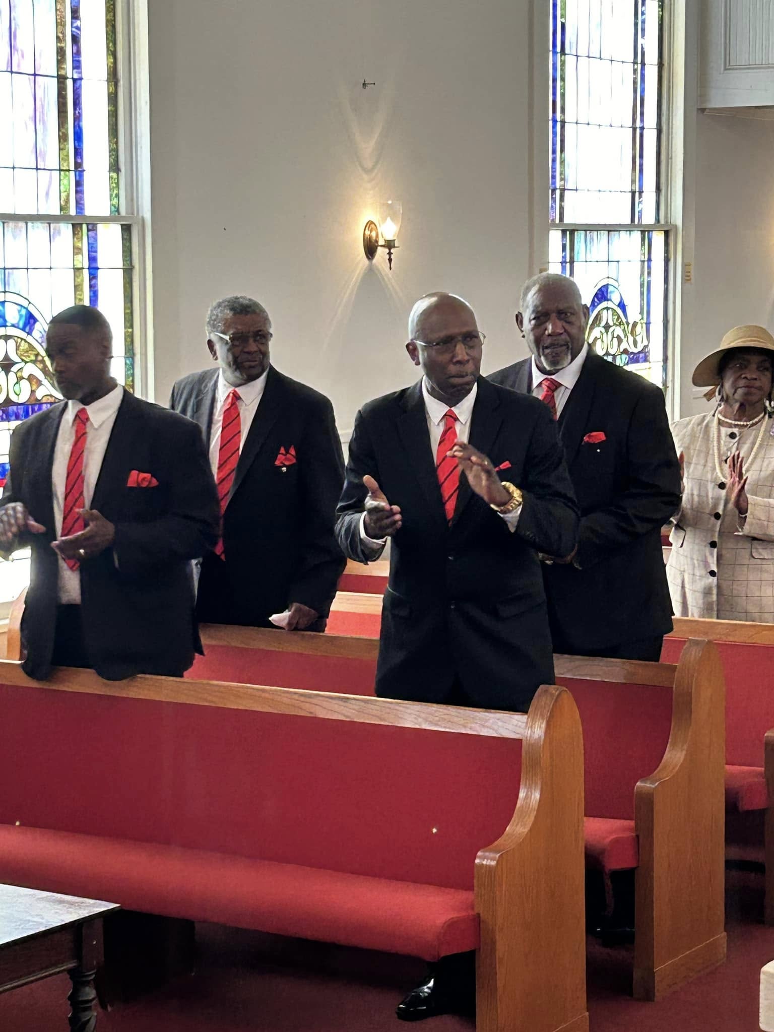 Men of FABC standing and clapping during worship