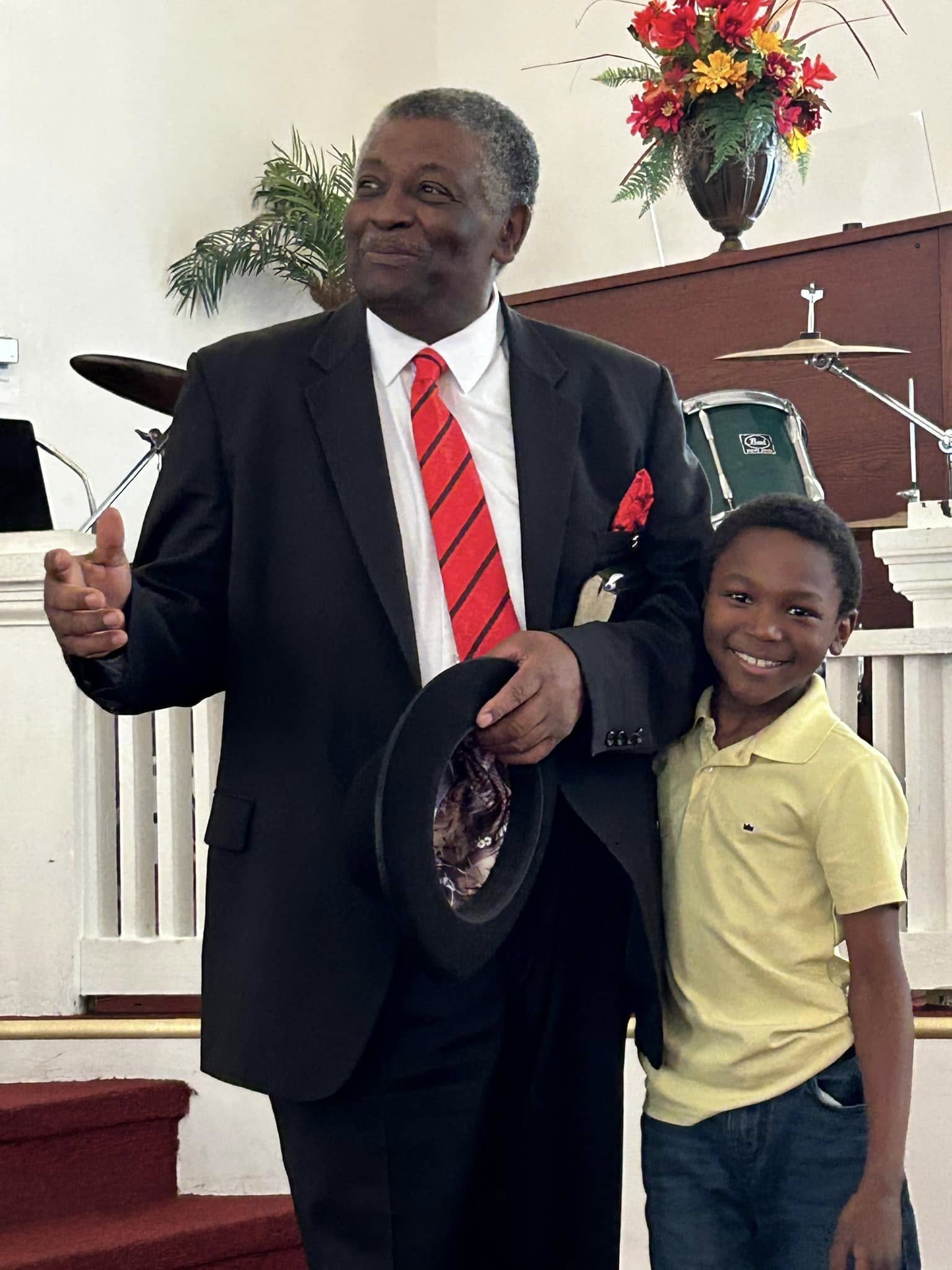 Deacon and young boy smiling at church