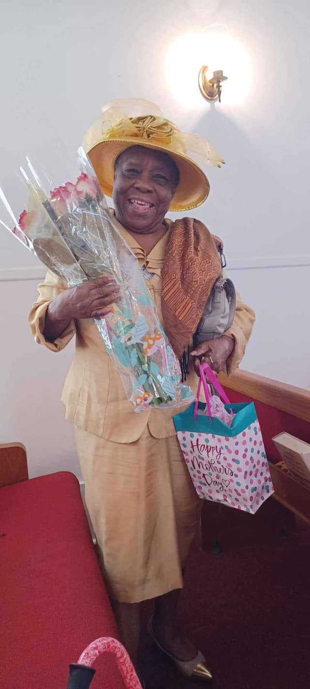 Mother of the church on Mother's Day with flowers and gifts
