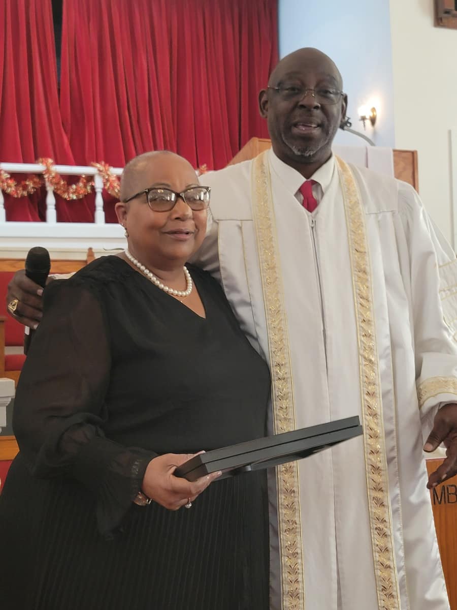 Pastor and church leader standing together at the pulpit
