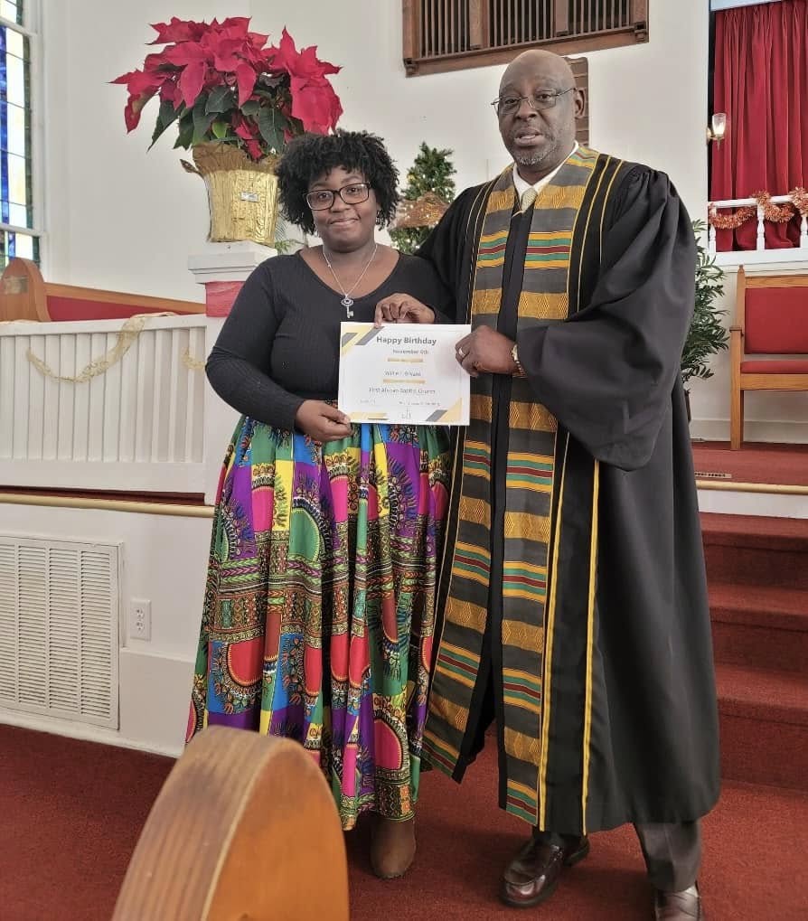 Pastor presenting a birthday recognition certificate